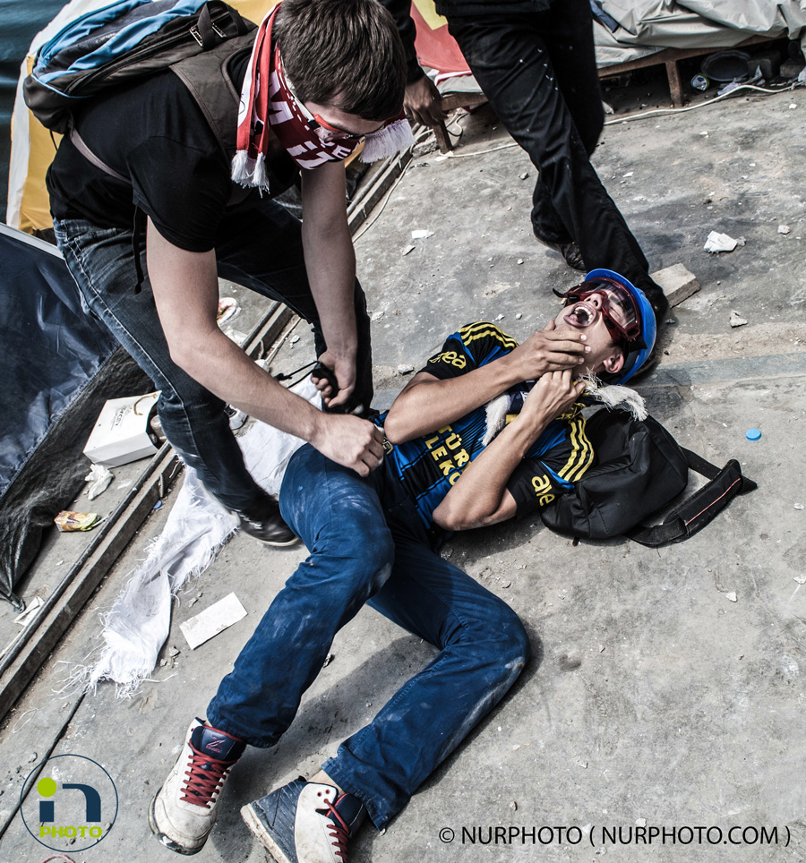 Clashes between police and protesters in Taksim Square. Police fired tear gas and water cannons in Taksim Square on June 11, 2013, the 11th day of anti-government protests in Turkey. In the photo: a protester hit during the clashes  Photo: Kaan Saganak/NurPhoto